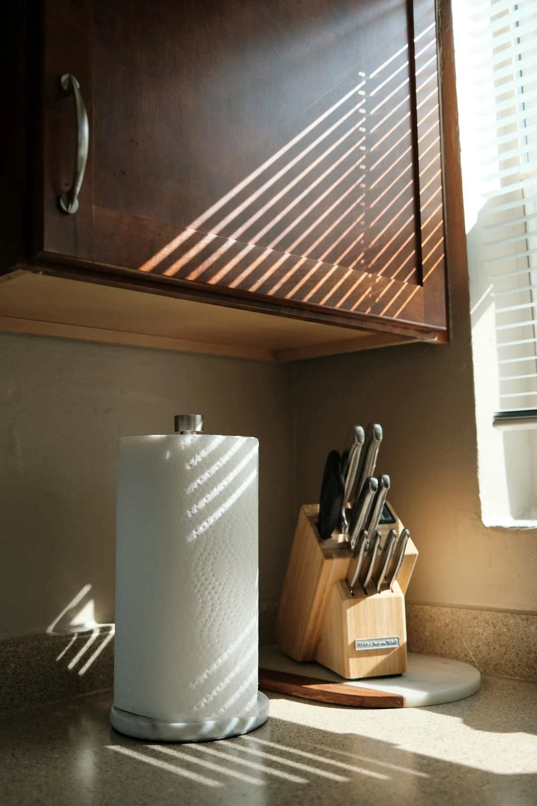 A worker in protective gear disinfects a kitchen, making sure the space stays clean and safe.